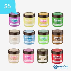 Display of all 12 Geladough Scented Dough flavors arranged together, featuring each scented dough container with its unique color and mix-ins for sensory play.